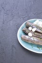 Herring fillets with onions on a blue plate, a traditional Dutch delicacy. Delicious seafood meal. Copy space. flat lay Royalty Free Stock Photo