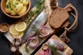 Herring fish  on wooden board  with pepper, herbs, red onion and lemon on black  background Royalty Free Stock Photo