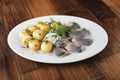 Herring fish with young potatoes balls