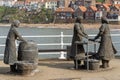Herring Girls wire statue by Emma Stothard, sculpture in Whitby, North Yorkshire, UK.