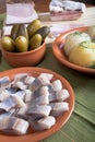 Herring, potato, pickles and bacon with plates on a green napkin Royalty Free Stock Photo