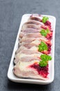 Herring slices stuffed with beetroot and potato arranged in a serving dish Royalty Free Stock Photo