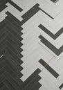 A herringbone pattern floor composed of alternating black and white rectangular tiles. Royalty Free Stock Photo