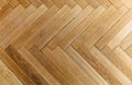 Herringbone pattern parquet wood floor texture. Wooden oak flooring background, overhead Royalty Free Stock Photo