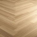 A herringbone-patterned wooden floor featuring light-toned planks with visible grain Royalty Free Stock Photo