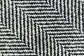 Herringbone tweed wool fabric texture background closeup. Natural organic wool cloth with classic pattern