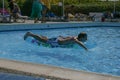 09.19.2008, Hersonissos, Crete, Greece. young guy swims in the pool on a water mattress.