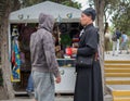 Hersonissos, Crimea - September 03, 2011: Monk collecting donations for the construction of the temple talking to the layman