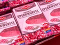 Herzhafte speckwÃ¼rfel packaging display with bacon snacks in tray Royalty Free Stock Photo
