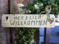 Herzlich willkommen sign translates into Welcome in English