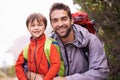 Hes already an avid little hiker. Portrait of a father and son enjoying a hike together.