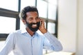 Hes always available to talk business. a businessman talking on a cellphone in an office. Royalty Free Stock Photo