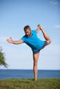 Hes always been a flexible guy. Full length shot of a handsome mature man doing yoga outdoors. Royalty Free Stock Photo