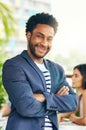 Hes been leading his team with great expertise. Portrait of a handsome young businessman standing outdoors with his Royalty Free Stock Photo