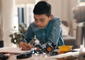 Hes always been a whiz kid. a handsome young boy doing his homework about robotics at home. Royalty Free Stock Photo