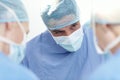 Hes a brilliant team leader. Cropped image of a male surgeon operating with fellow surgeons in an operating theatre. Royalty Free Stock Photo