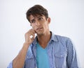 Hes always on call. Handsome young ethnic man looking sideways while speaking on his cellphone. Royalty Free Stock Photo