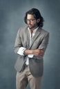 Hes a classy gentleman. Cropped studio shot of a handsome and stylish young man against a grey background. Royalty Free Stock Photo