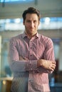 Hes confident and competent. Portrait of a handsome man standing in an office.