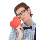 Hes content with Valentines Day and all that comes with it. Portrait of a geeky young man holding a heart.