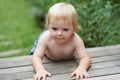 Hes a curious baby boy. A sweet little baby boy crawling outside.