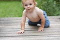 Hes a curious baby boy. A sweet little baby boy crawling outside.