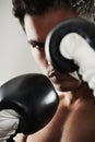 Hes dedicated to the sport of boxing. Closeup portrait of a young male boxer in a fighting stance. Royalty Free Stock Photo