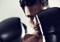 Hes dedicated to the sport of boxing. Closeup portrait of a young male boxer in a fighting stance. Royalty Free Stock Photo