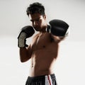 Hes dedicated to the sport of boxing. a young male boxer in a fighting stance. Royalty Free Stock Photo