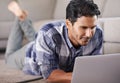 Hes deeply immersed in the world wide web. A young man using his laptop at home. Royalty Free Stock Photo