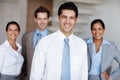 Hes earned his place as a leader. A young business leader standing in front of his team smiling confidently. Royalty Free Stock Photo