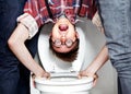 Hes an easy target. Closeup portrait of a nerdy guy getting dunked in the school toilet. Royalty Free Stock Photo