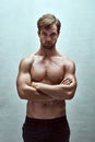 Hes enough to give any girl butterflies. a handsome bare-chested young man posing in the studio.