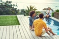 Hes finally letting her know how he feels. a group of friends having drinks and enjoying themselves poolside on holiday. Royalty Free Stock Photo