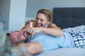 Hes forever her bunny bear. an attractive young woman being playful with her husband while lying in bed in the morning. Royalty Free Stock Photo