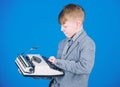 Hes going to write a composition. Smart child writer. Little writer typing on retro typewriter. Cute boy writer working