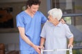 Hes really good with his senior patients. a male doctor assisting his senior patient whos using a walker for support. Royalty Free Stock Photo