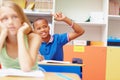 Hes got the answer. Young african-american boy raising his hand in class to answer a question - copyspace. Royalty Free Stock Photo