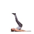 Hes got perfect technique. A fit young man stretching his legs on an exercise mat - isolated. Royalty Free Stock Photo