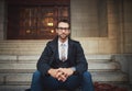 Hes got some serious style. Portrait of a stylish young man sitting on steps in the city. Royalty Free Stock Photo