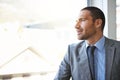 Hes got a vision for his future. a handsome businessman looking out of his office window. Royalty Free Stock Photo