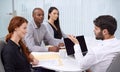 Hes a great team leader. A group of coworkers sitting in an office having a meeting. Royalty Free Stock Photo