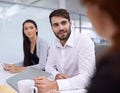 Hes a great team leader. a group coworkers sitting in an office having a meeting. Royalty Free Stock Photo