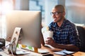 Hes always hungry for success. Portrait of a young designer eating takeaways while working at his office desk. Royalty Free Stock Photo