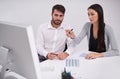 Hes impressed by her business proposal. two young business colleagues discussing work in the office. Royalty Free Stock Photo