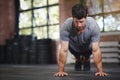 Hes a lean mean machine. a young man doing pushups in a gym. Royalty Free Stock Photo