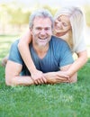 Hes the love of her life. Portrait of a mature man enjoying his wifes affections in the park. Royalty Free Stock Photo