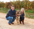 Hes a member of their family. Portrait of a young couple with their pet Alsatian on a wine farm. Royalty Free Stock Photo