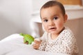 Hes the most adorable boy youll meet. Portrait of an adorable baby girl playing with a toy dinosaur. Royalty Free Stock Photo