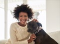 Hes my best friend. Portrait of an attractive young woman petting her dog while sitting on the sofa at home. Royalty Free Stock Photo